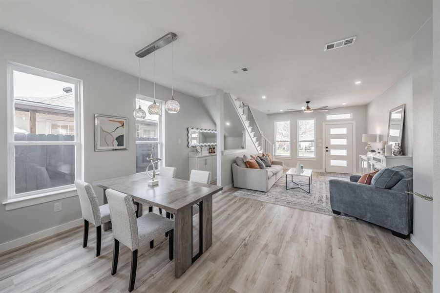 Dining area with ceiling fan and light hardwood / wood-style flooring