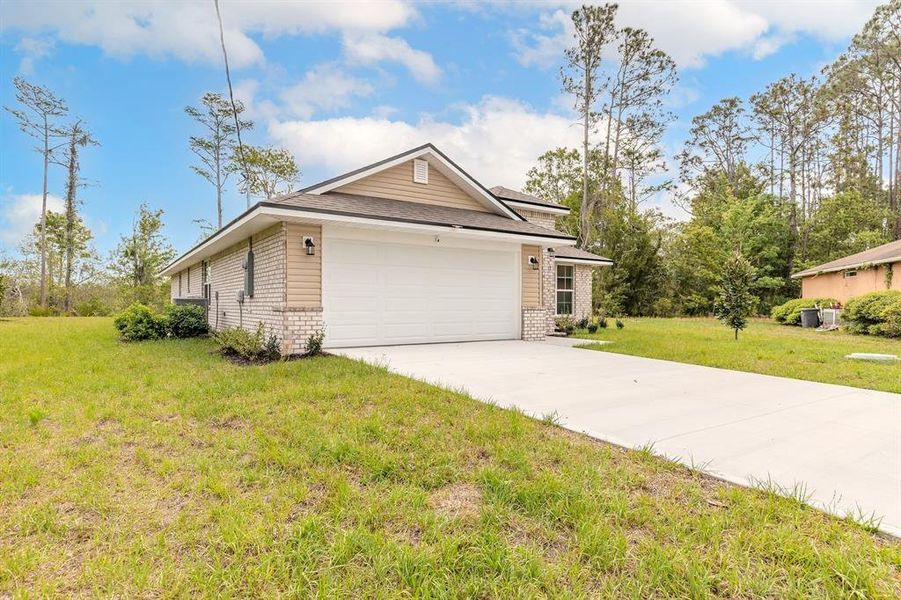 Front exterior of a new home in Palm Coast, Palm Coast, FL, highlighting curb appeal (Image 22).