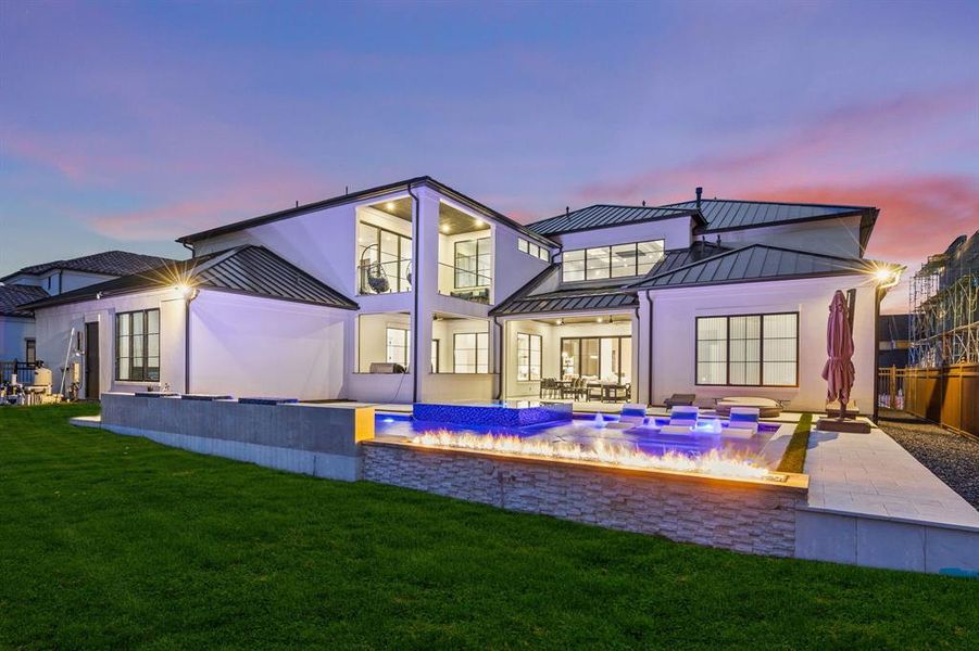 Pool at dusk with an in ground hot tub and a patio area