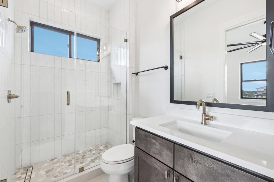 Bathroom featuring a stall shower and vanity
