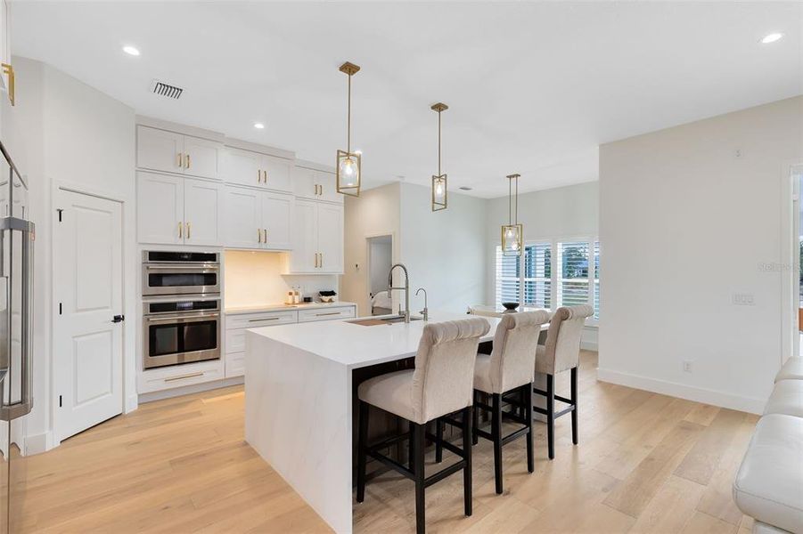 You'll also enjoy quartz counters, stainless steel café appliances, and ample soft-close cabinetry.