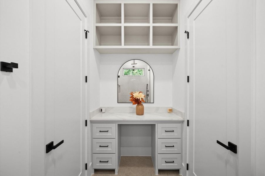 Additional vanity area. The home features multiple storage areas.