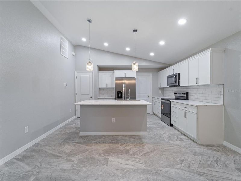 Plenty of storage with island, cabinets, and pantry