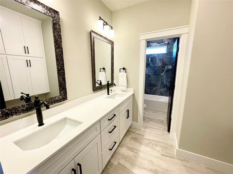 Bathroom with vanity, shower / washtub combination, and tile patterned floors