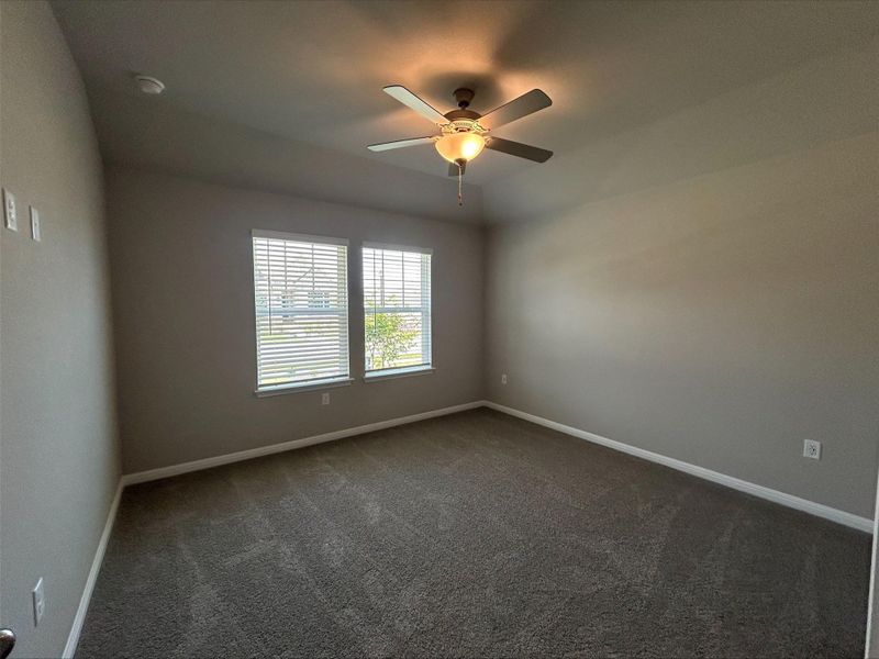 Spare room featuring carpet and a ceiling fan Spare room featuring carpet and a ceiling fan
