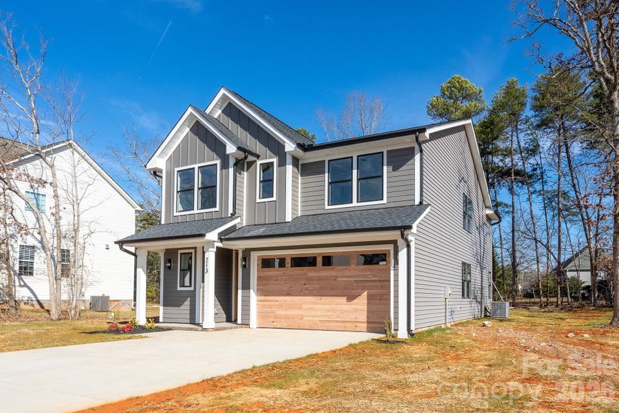 Front exterior of a new home in , Locust, NC, highlighting curb appeal (Image 19).