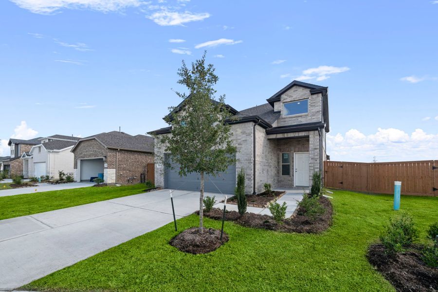 Front exterior of a new home in River Ranch, Dayton, TX, highlighting curb appeal (Image 20). Front exterior of a new home in River Ranch, Dayton, TX, highlighting curb appeal (Image 20).