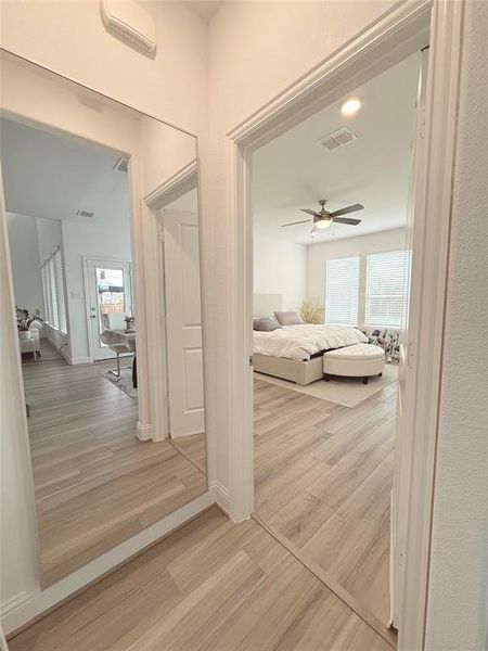 Hall with light wood-style flooring and recessed lighting