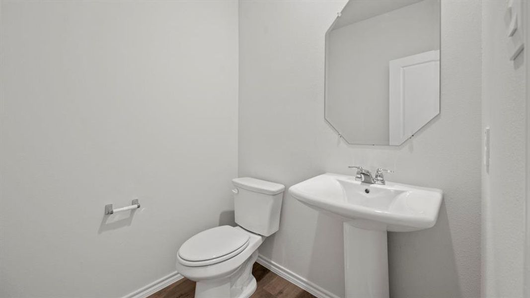 Bathroom featuring toilet and dark wood finished floors