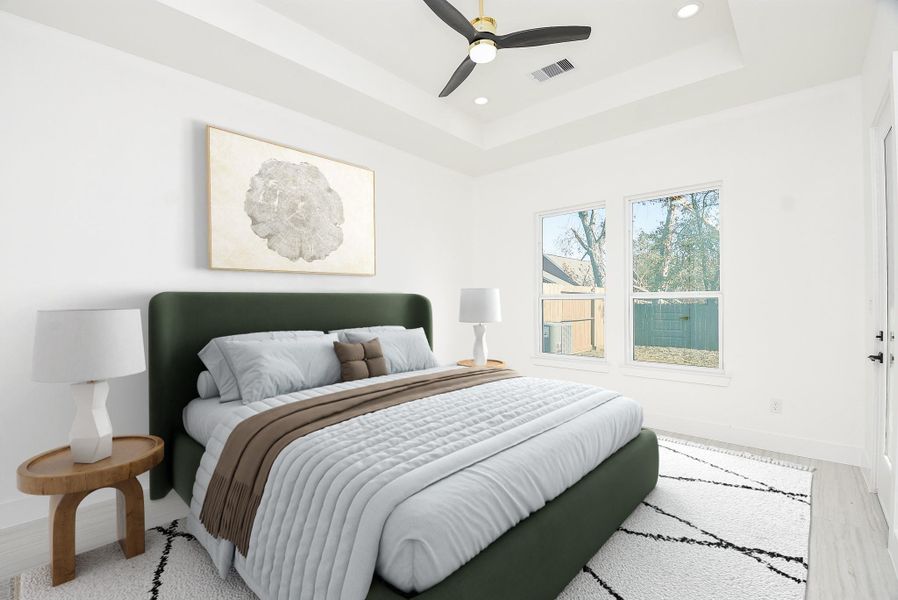 Retreat to this elegant primary suite, featuring soaring tray ceilings and tall windows that fill the space with natural light. Located on the first floor for added comfort and privacy, this serene sanctuary is the perfect place to unwind.