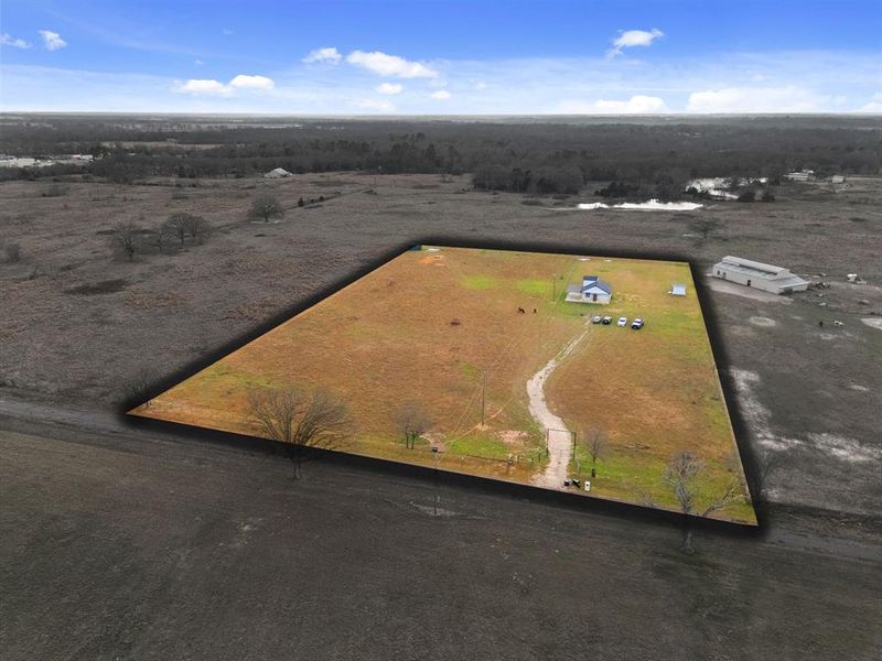 Expansive acreage with a single-story residence and outbuildings Expansive acreage with a single-story residence and outbuildings