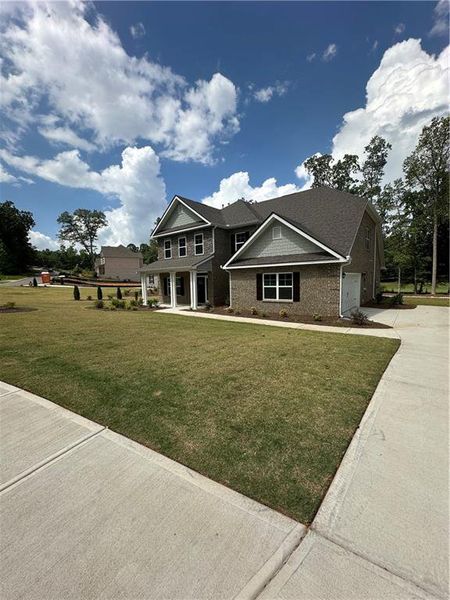 Front exterior of a new home in Mirror Lake at South Harbour, Villa Rica, GA, highlighting curb appeal (Image 14).