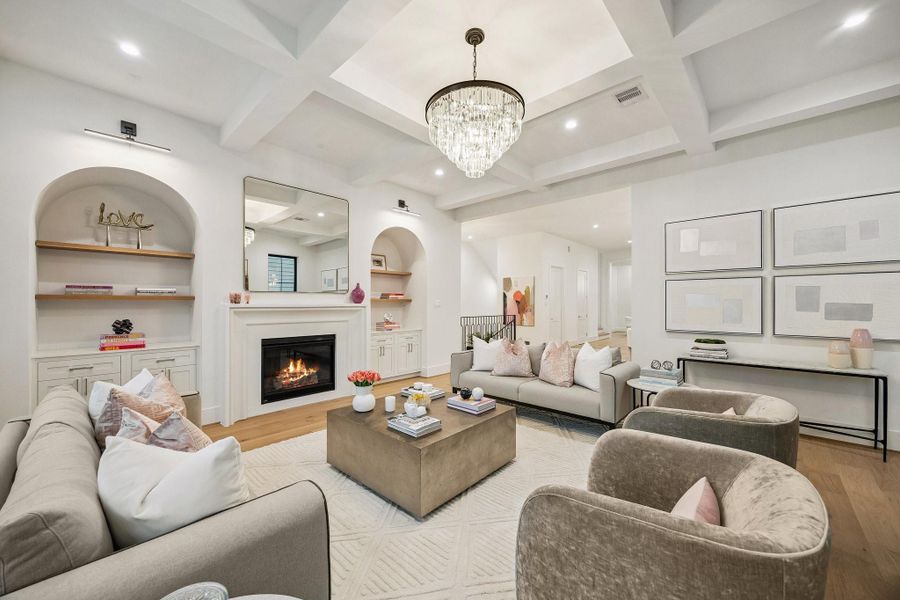 Another view of the Living Room Showcases the Shaker Style Inset Cabinets Doors, White Oak Floating Shelves with a Natural Stain, Dimmable 23.6 Inch LED Gallery Lamps in Warm White. There is also a Conduit above the Fireplace for a TV.