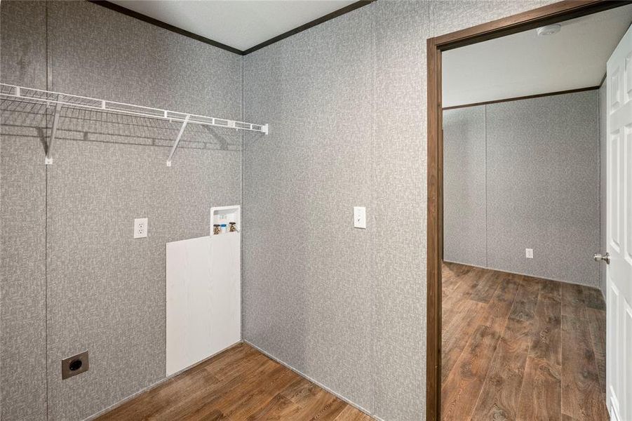 Laundry area with electric dryer hookup, wood finished floors, crown molding, and washer hookup