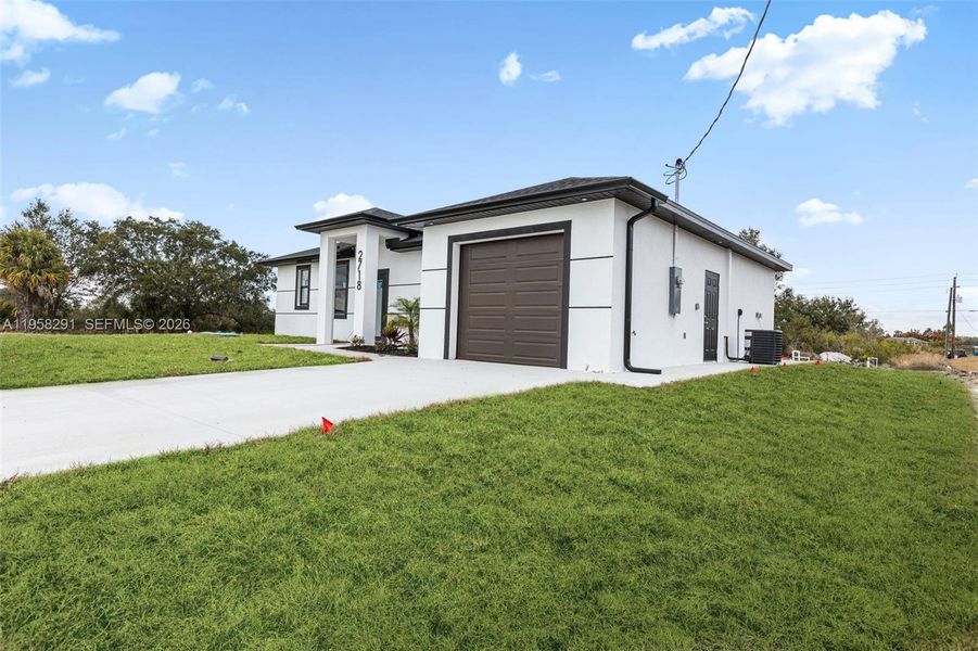 Front exterior of a new home in , Lehigh Acres, FL, highlighting curb appeal (Image 28).