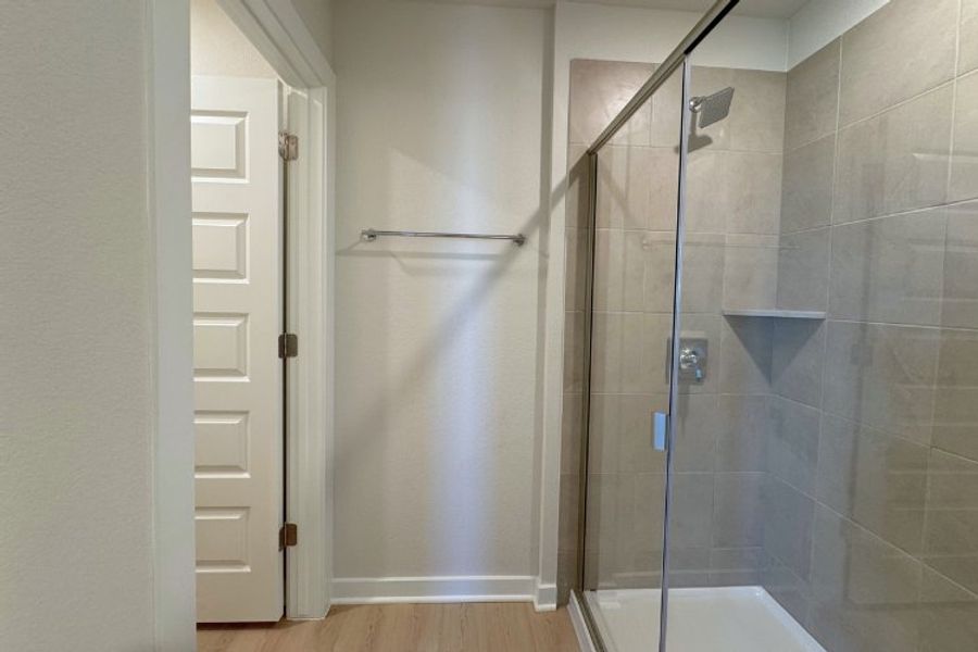 A shower with a glass door.