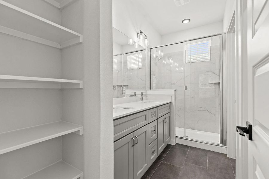 Dual vanities and a spacious glass-enclosed shower create a rejuvenating sanctuary. Dual vanities and a spacious glass-enclosed shower create a rejuvenating sanctuary.