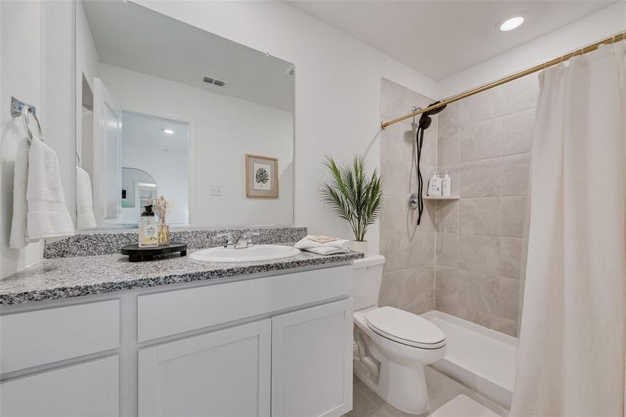 Full bath with vanity, tiled shower, and recessed lighting Full bath with vanity, tiled shower, and recessed lighting
