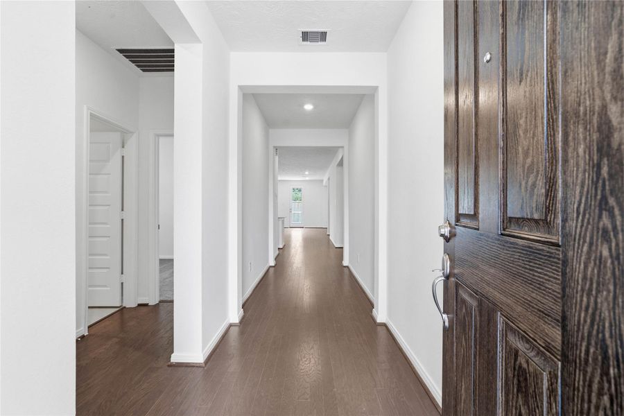 Step into a bright and welcoming foyer that sets a sophisticated tone for the rest of the home. This inviting entrance features engineered wood flooring that seamlessly guides you into the main living areas. Step into a bright and welcoming foyer that sets a sophisticated tone for the rest of the home. This inviting entrance features engineered wood flooring that seamlessly guides you into the main living areas.