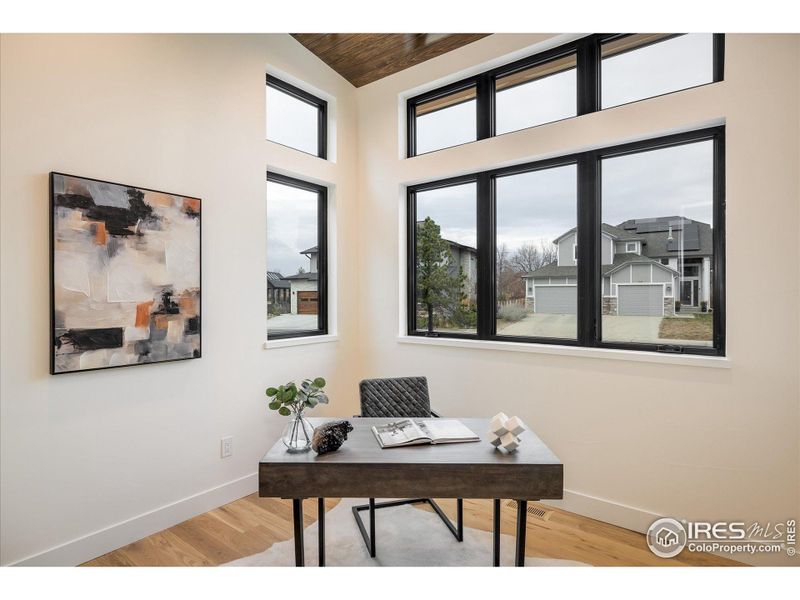 A light-filled main floor study with stunning tongue and groove wood ceiling