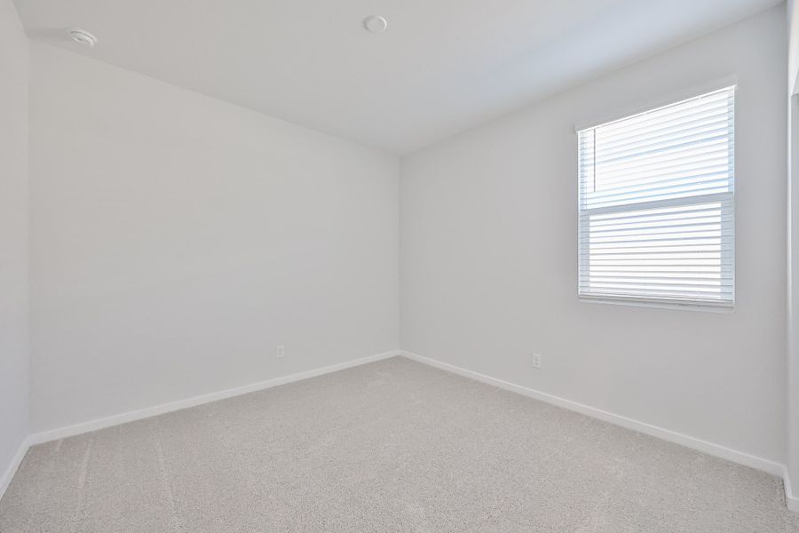 A room with a window and a carpet. A room with a window and a carpet.