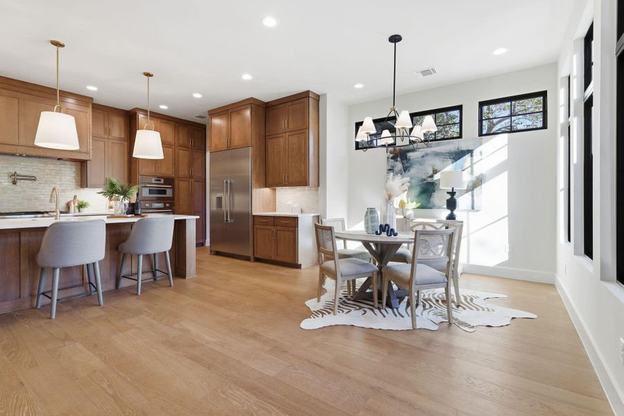 Dining space with a chandelier, light wood finished floors, and recessed lighting