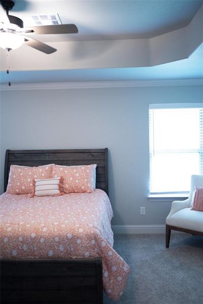 Bedroom featuring baseboards, visible vents, ceiling fan, and carpet Bedroom featuring baseboards, visible vents, ceiling fan, and carpet