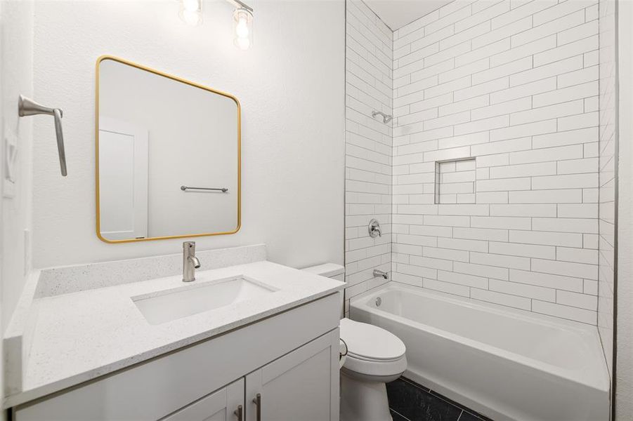 Full bathroom featuring shower / bath combination, toilet, and vanity