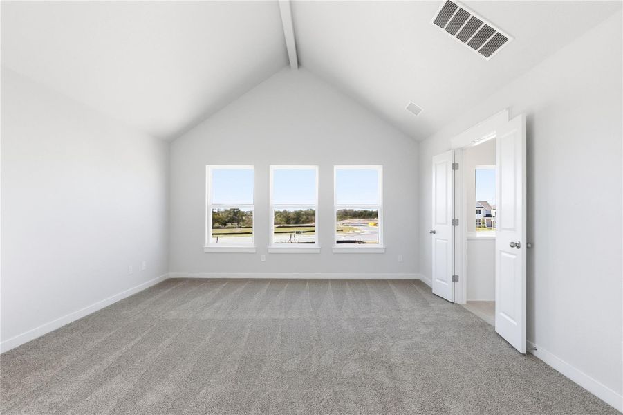 Unfurnished room with beamed ceiling, light carpet, and high vaulted ceiling