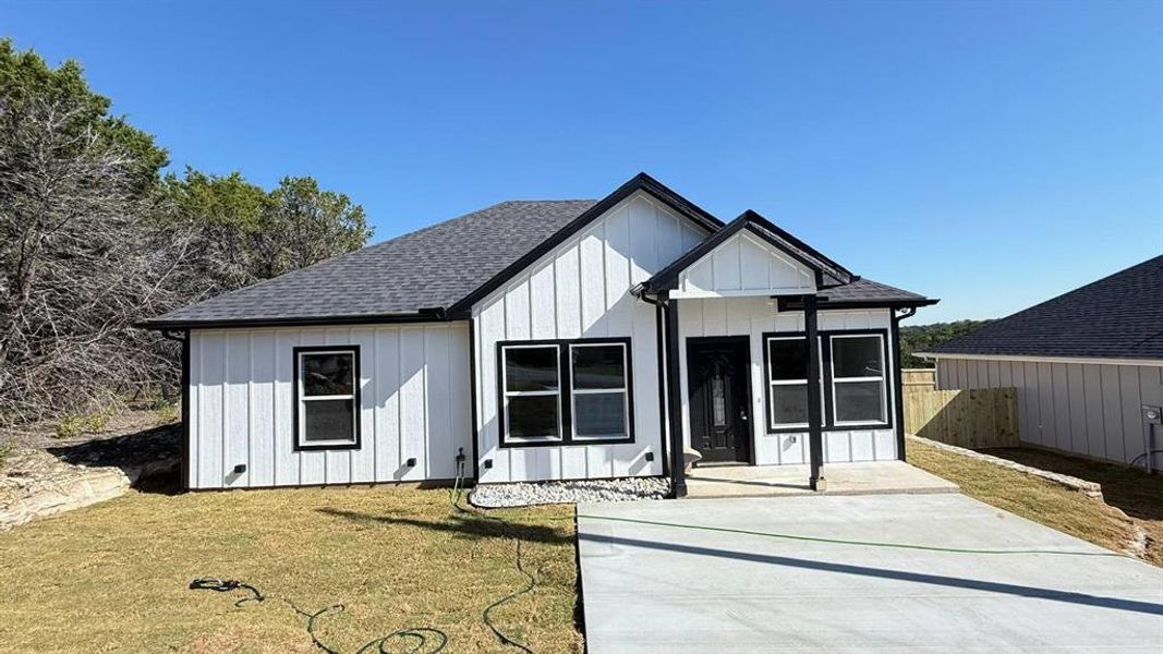 Modern farmhouse with a shingled roof and board and batten siding