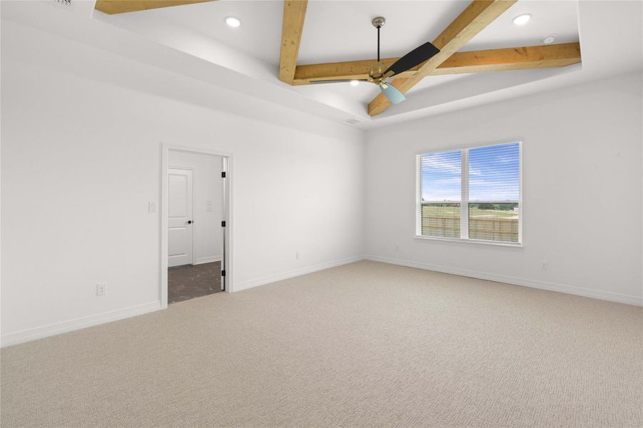 A tranquil primary bedroom with a vaulted ceiling and a picturesque view of the landscape. A tranquil primary bedroom with a vaulted ceiling and a picturesque view of the landscape.
