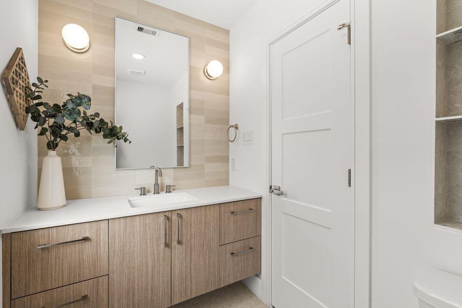 Defined by clean lines and visual lightness, the powder bath employs a floating vanity and wall-mounted elements to create a sense of openness within a compact footprint.