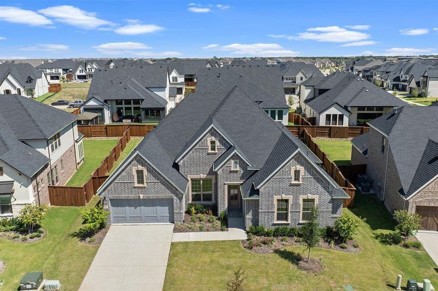 Front exterior of a new home in Windsong Ranch, Prosper, TX, highlighting curb appeal (Image 19). Front exterior of a new home in Windsong Ranch, Prosper, TX, highlighting curb appeal (Image 19).
