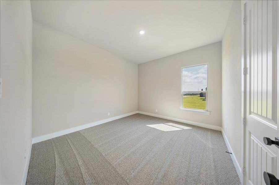 Carpeted empty room with baseboards and recessed lighting Carpeted empty room with baseboards and recessed lighting
