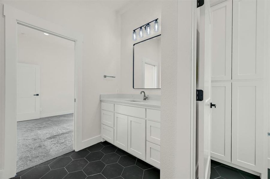 Bathroom featuring vanity and tile patterned flooring