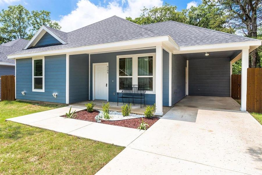 View of front of property with covered porch and a carport