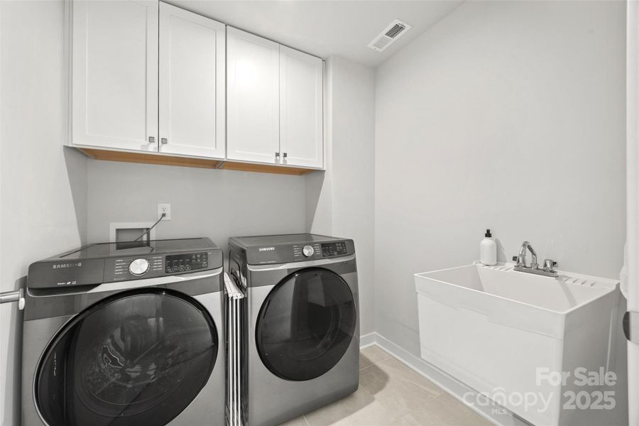 Laundry room with storage and utility sink Laundry room with storage and utility sink