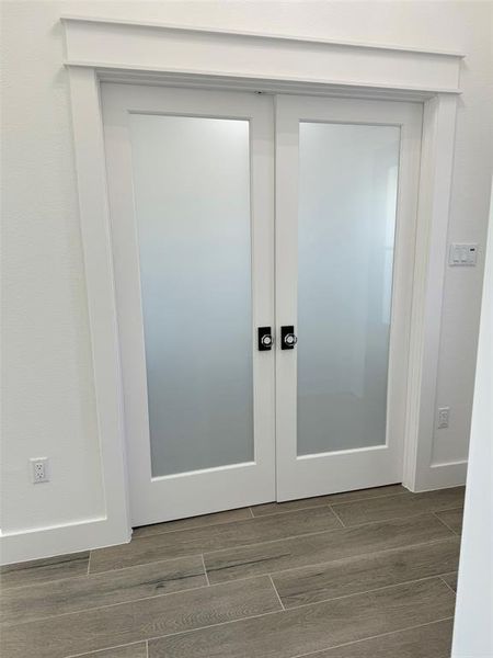 Customized double doors leading to the flex room