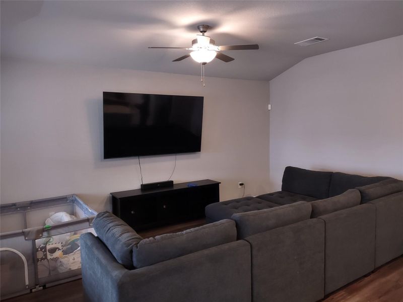 Living room with wood finished floors and ceiling fan