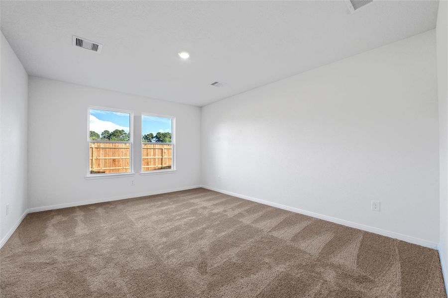 Relax and recharge in this stunning primary suite! Enjoy the comfort of plush carpeting, neutral-toned walls, high ceilings, and expansive windows that fill the room with natural light. Relax and recharge in this stunning primary suite! Enjoy the comfort of plush carpeting, neutral-toned walls, high ceilings, and expansive windows that fill the room with natural light.