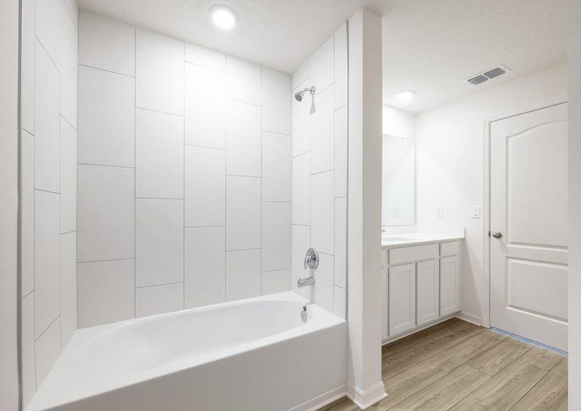 The master bathroom shower has gorgeous white tile.