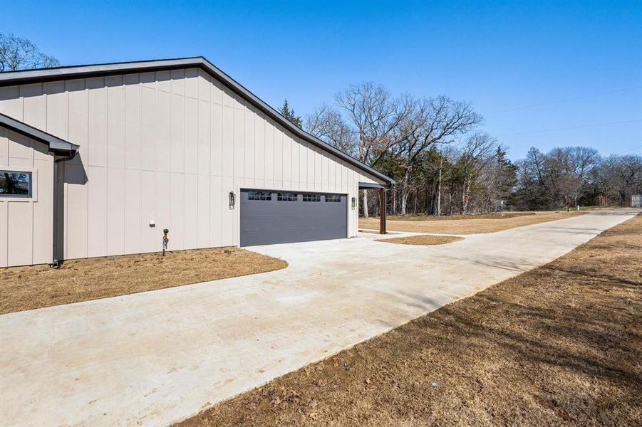 View of property exterior featuring a garage