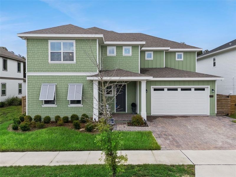 Front exterior of a new home in Weslyn Park at Sunbridge, St. Cloud, FL, highlighting curb appeal (Image 2).