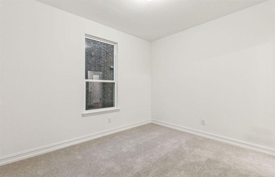 Roomy secondary bedroom with extensive closet storage *Real home pictured