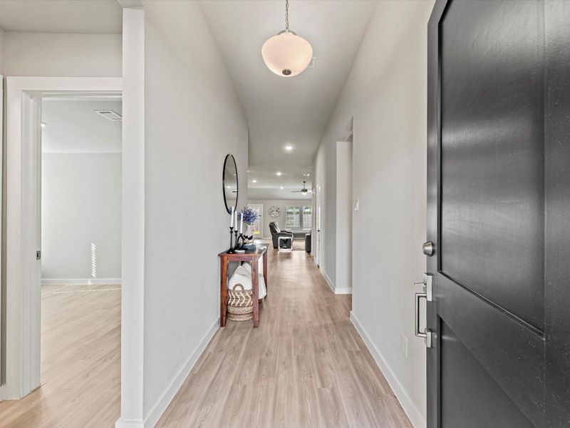 Wide entry hallway with luxury vinyl flooring leading into the main living area.