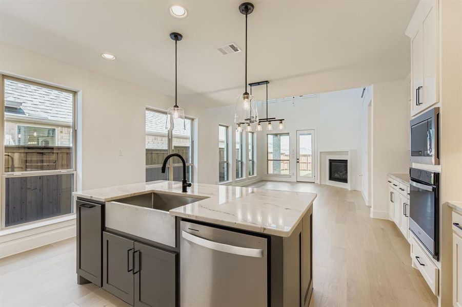 Kitchen featuring stainless steel appliances, light wood-style floors, plenty of natural light, and recessed lighting Kitchen featuring stainless steel appliances, light wood-style floors, plenty of natural light, and recessed lighting