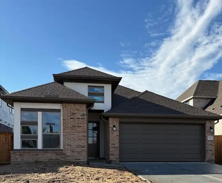 Front exterior of a new home in The Highlands 45', Porter, TX, highlighting curb appeal (Image 2).