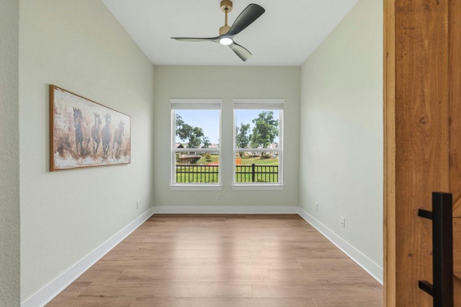 The Study is bathed in natural light, thanks to a pair of expansive windows that showcase picturesque views of the lush Side Yard and tranquil Sheffield Lake. Bright, airy, and inviting, this thoughtfully designed space provides the perfect setting for work or quiet reflection.