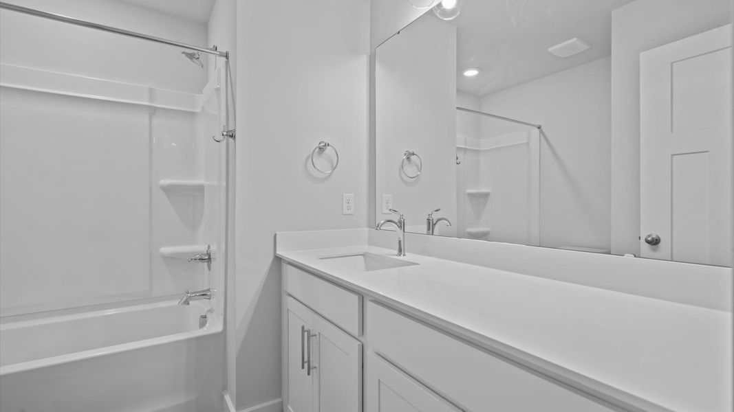 Accomplished bathroom design with sleek tile, high-quality cabinetry, and refined hardware Accomplished bathroom design with sleek tile, high-quality cabinetry, and refined hardware