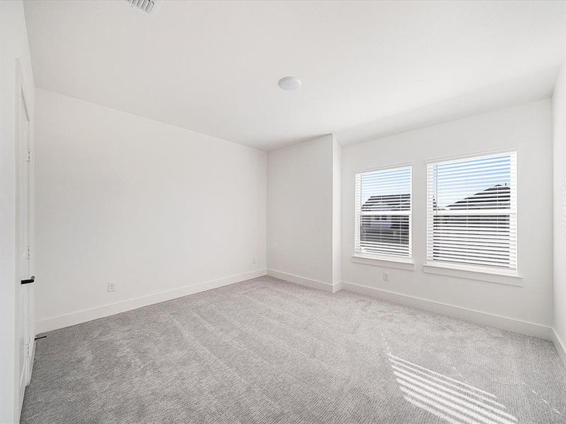 Carpeted empty room featuring baseboards